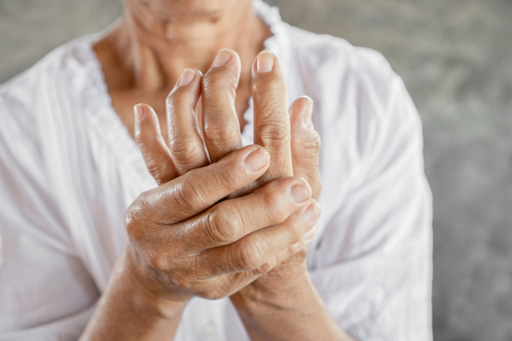woman suffer from hand arthritis pain