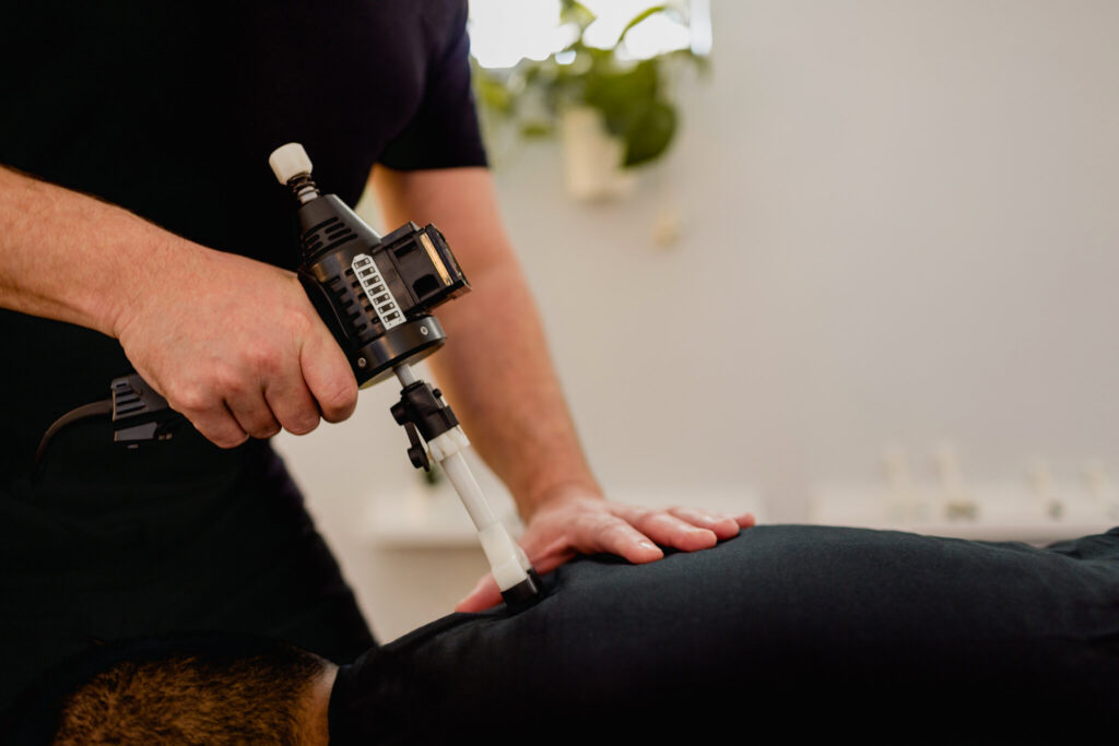 doctor giving patient arthrostim treatment for back pain